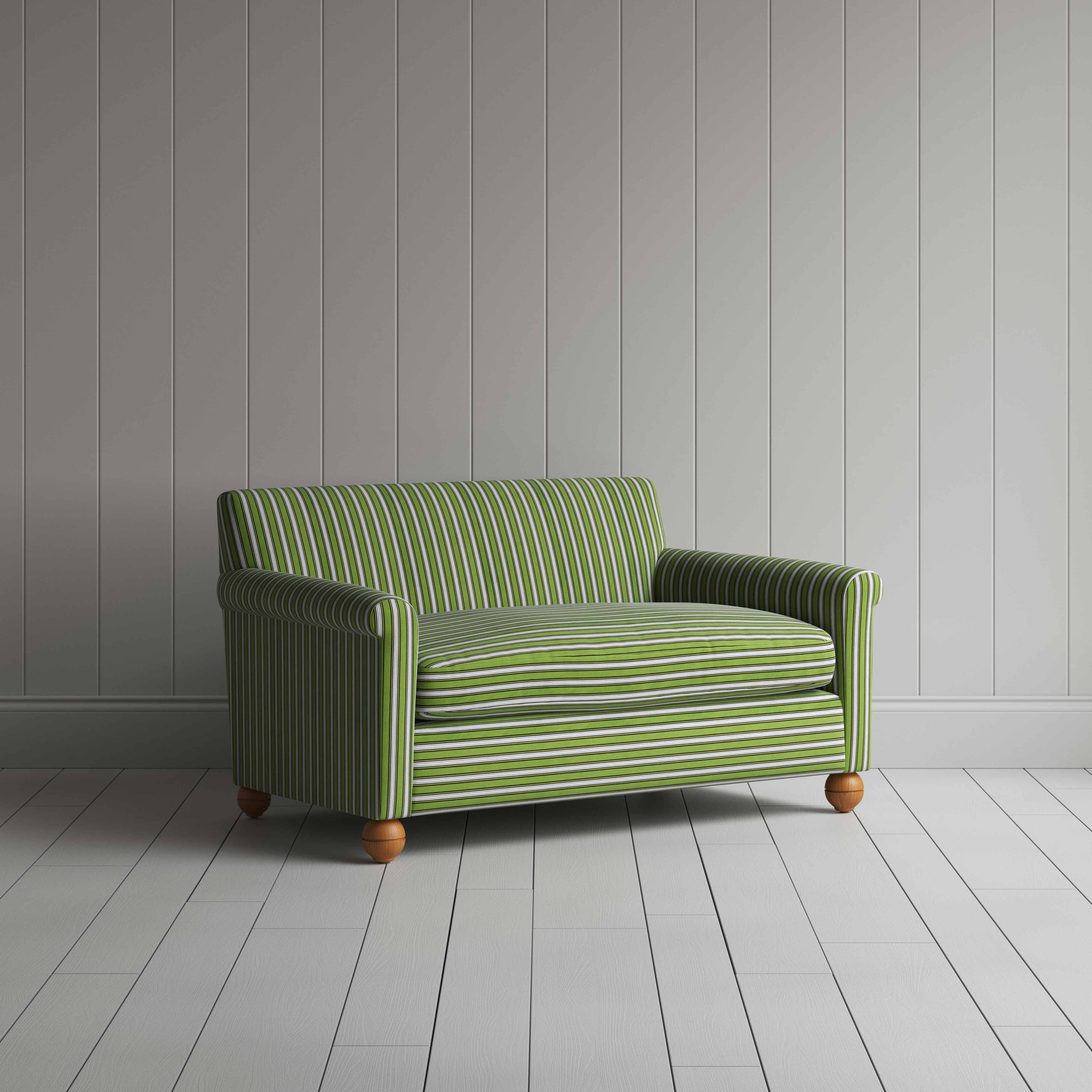Striped green and white sofa by a wall.