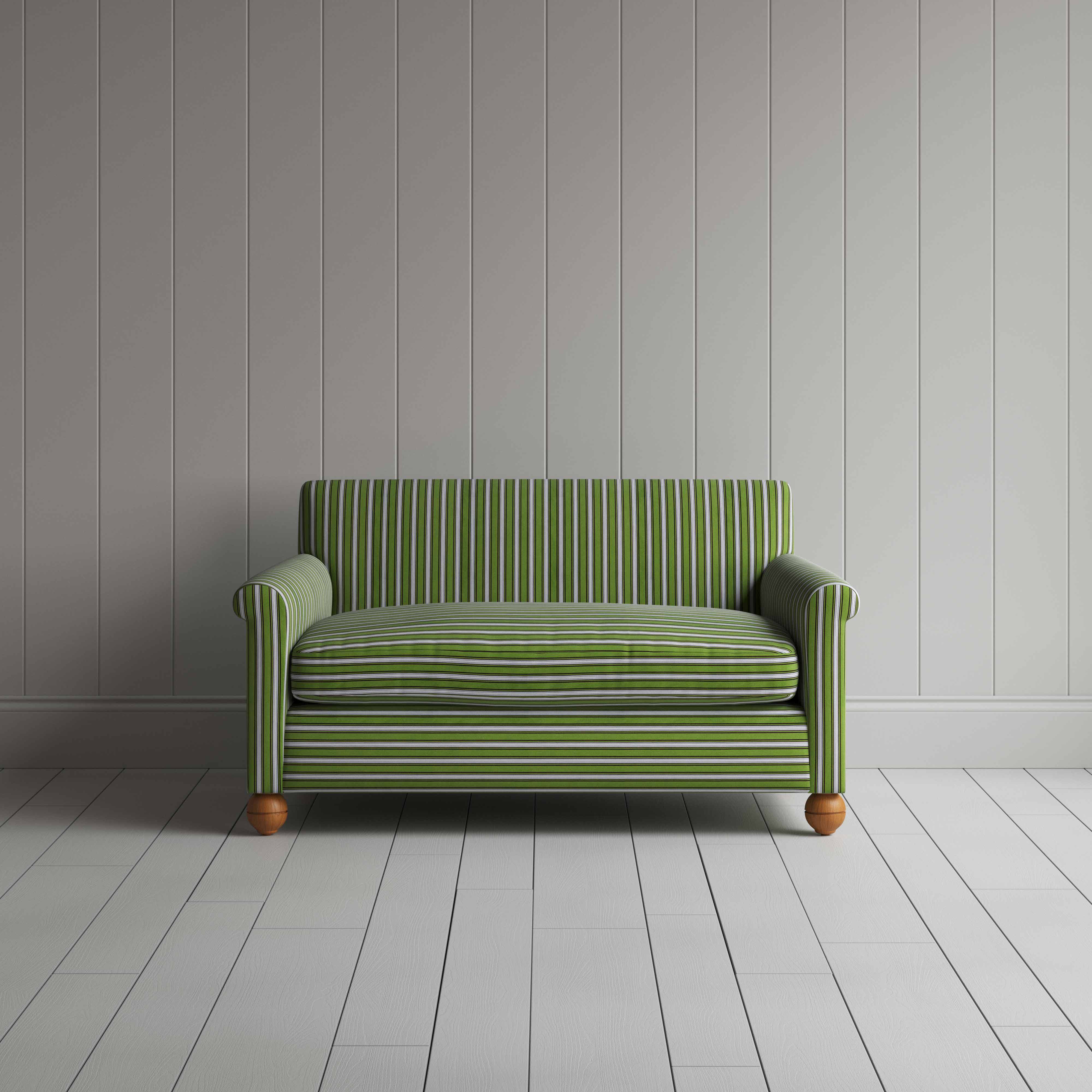 A green and white striped couch against a wall.