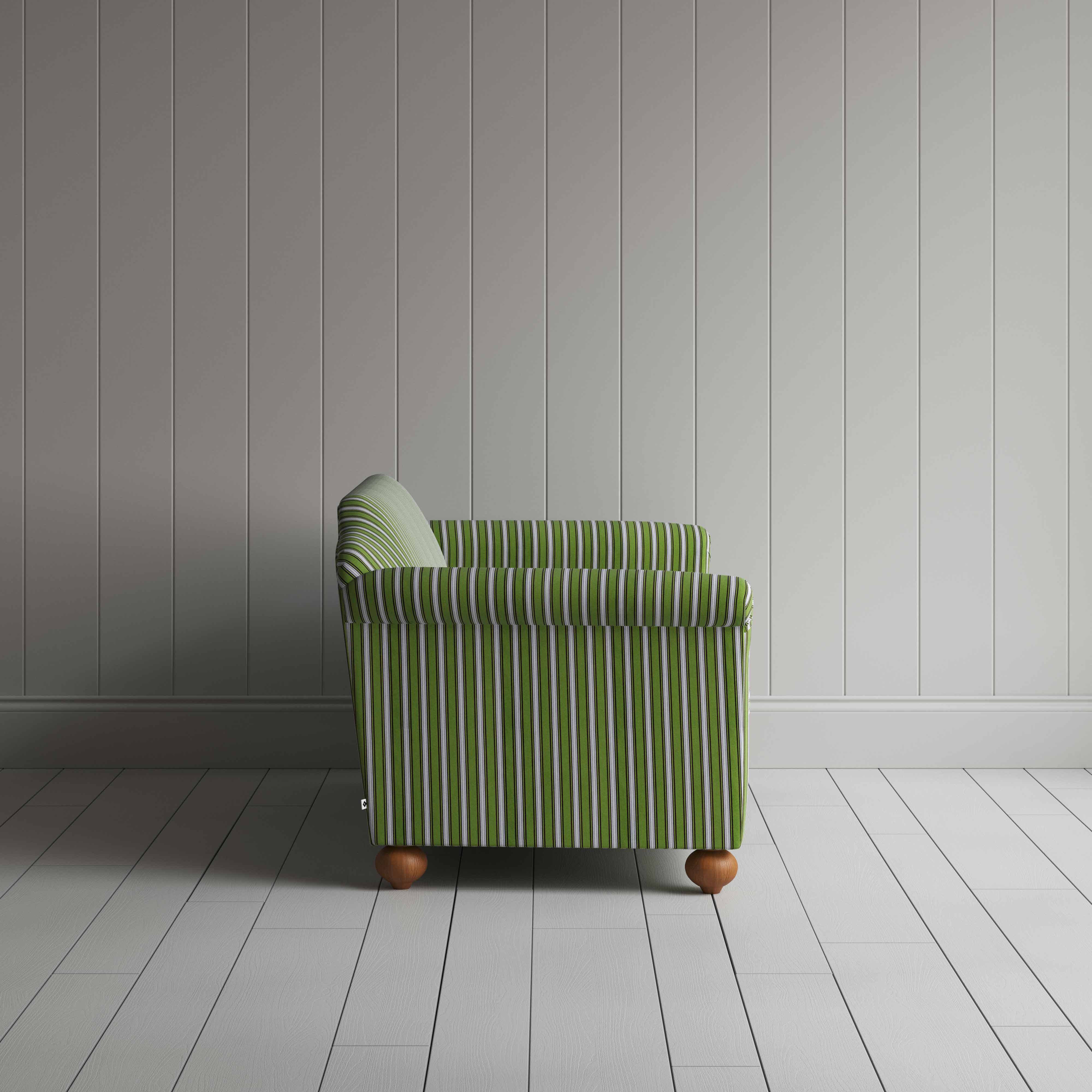 Striped green and white sofa next to a wall.