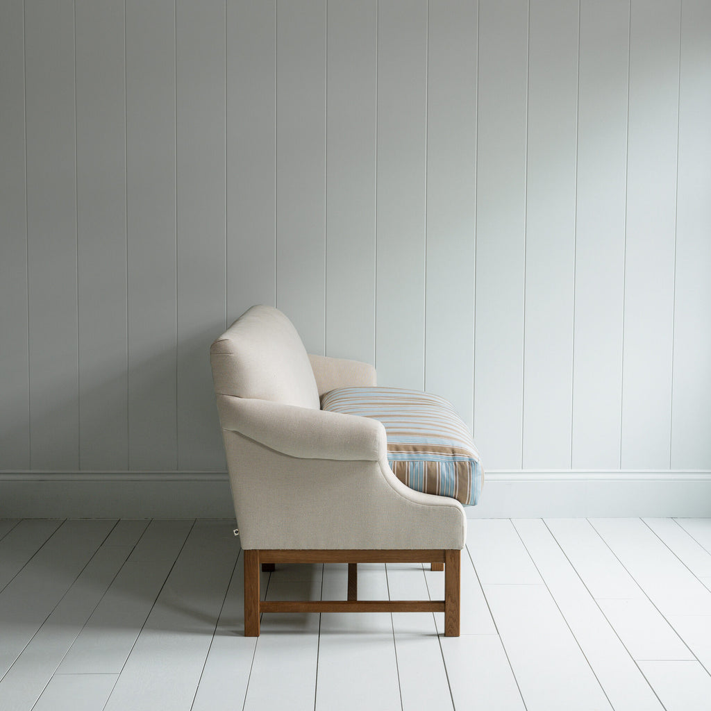 Side View of Front Row 3 Seater Upholstered Bench in Laidback Linen Dove Frame and Regatta Cotton Blue Seat -  By Nicola Harding & Co.