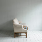 Side View of Front Row 3 Seater Upholstered Bench in Laidback Linen Dove Frame and Regatta Cotton Blue Seat -  By Nicola Harding & Co.