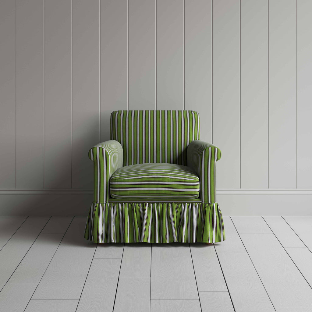 Elegant green and white striped armchair featuring a charming ruffled skirt, ideal for a stylish home decor.