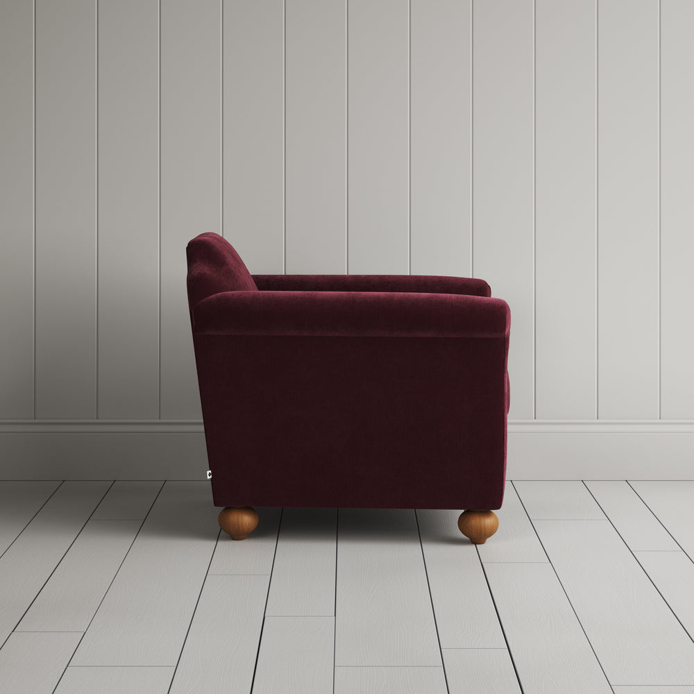 Side profile of the Cherry red corduroy Dolittle armchair - NiX