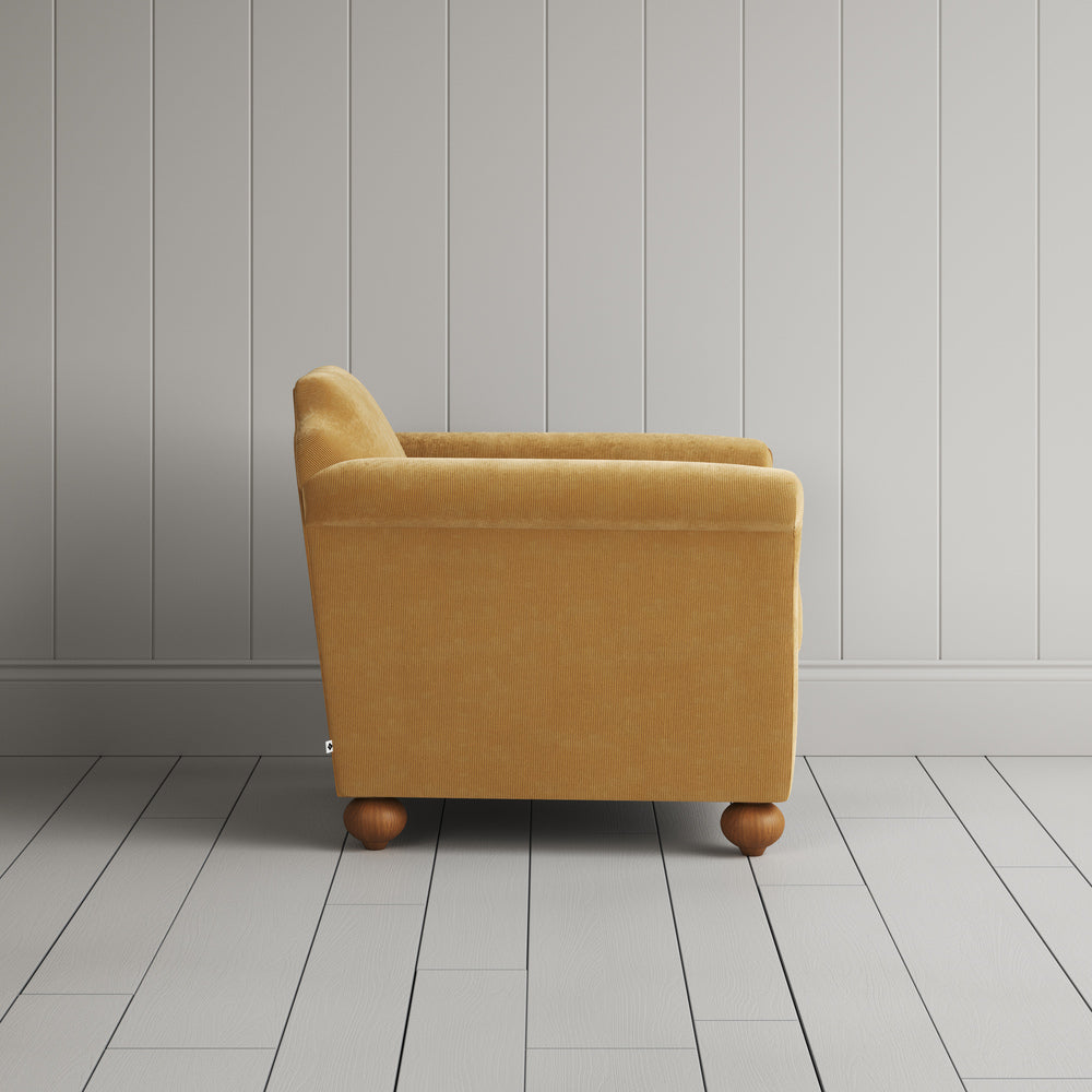 Side profile of the Wheat corduroy Dolittle armchair