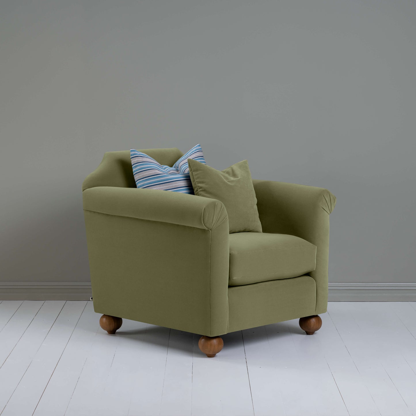 Dolittle Armchair in Intelligent Velvet Green Tea, In Side View With 1 Matching and 1 Slow Lane Cotton Linen, Blue Cushion - Nicola Harding