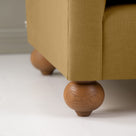 Dolittle Armchair in Laidback Linen Ochre, Round Wooden Foot Closeup - Nicola Harding