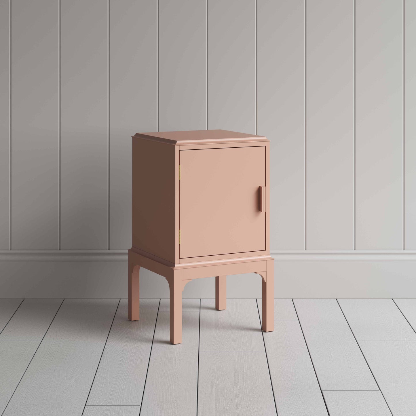 A small pink bedside table with a side door, perfect for storing items discreetly and adding a pop of color to any room.