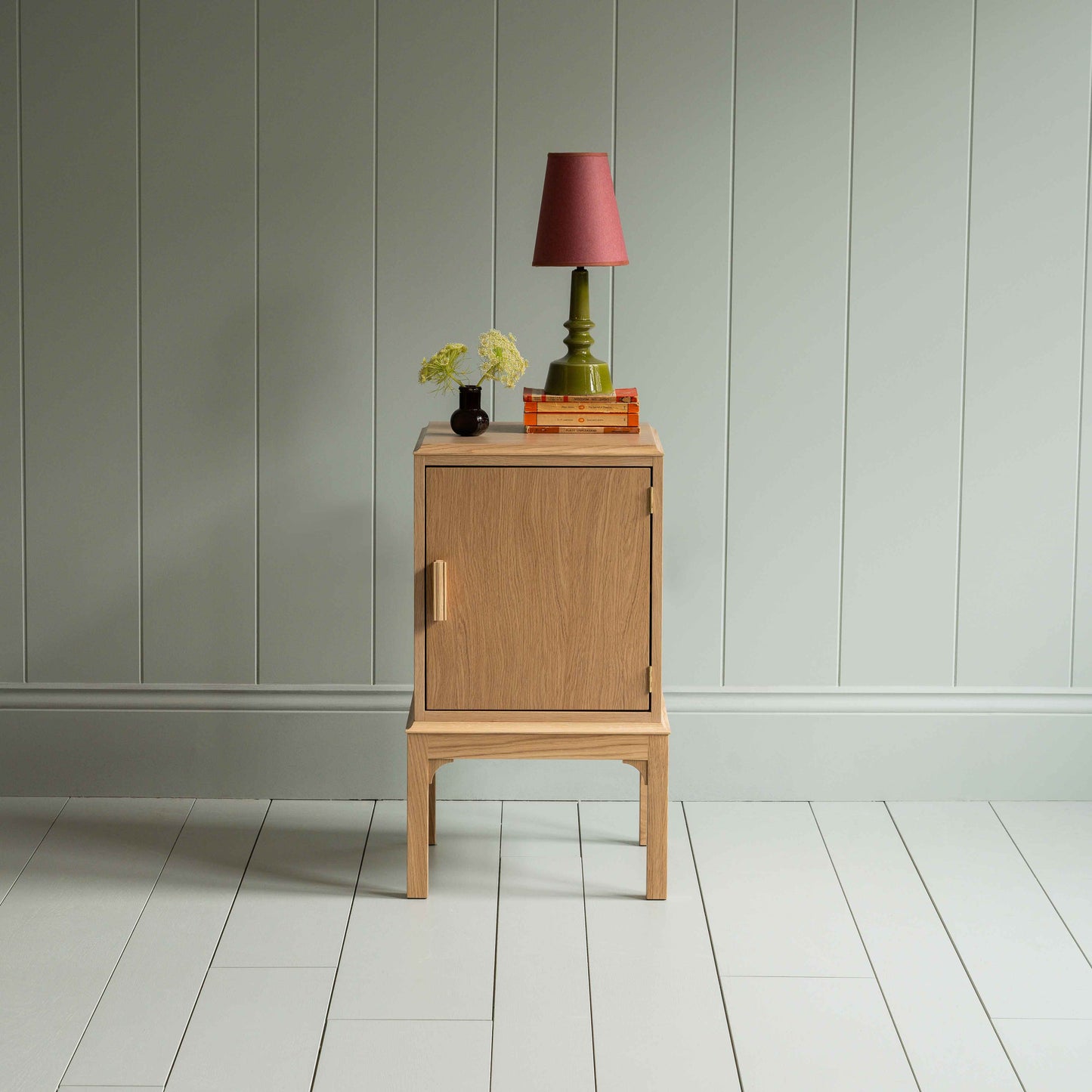 Bits and Bobs Bedside Table, Natural Oak, Right Hand Side Decorated with table lamp and a small flower bottle - Nicola Harding