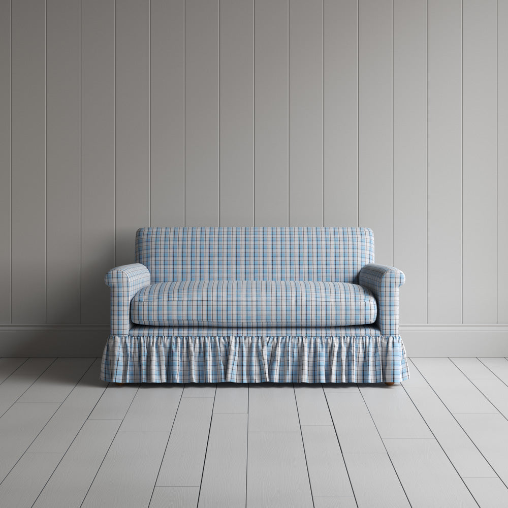Symmetrical front view of the patterned cotton NiX sofa highlighting its gathered skirt base.