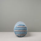 Side View of Bask Bolster Cushion in Slow Lane Cotton Linen, Blue - Nicola Harding