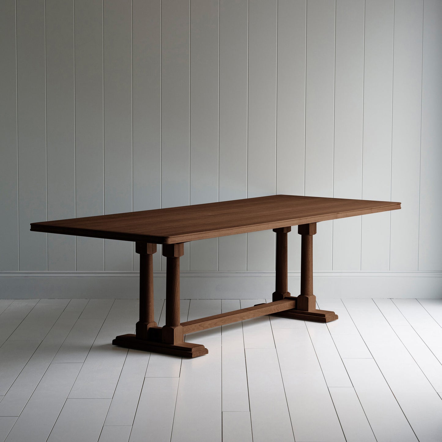 Side tile view of Tuck In rectangular dining table in smoky stained oak wood, by NiX.