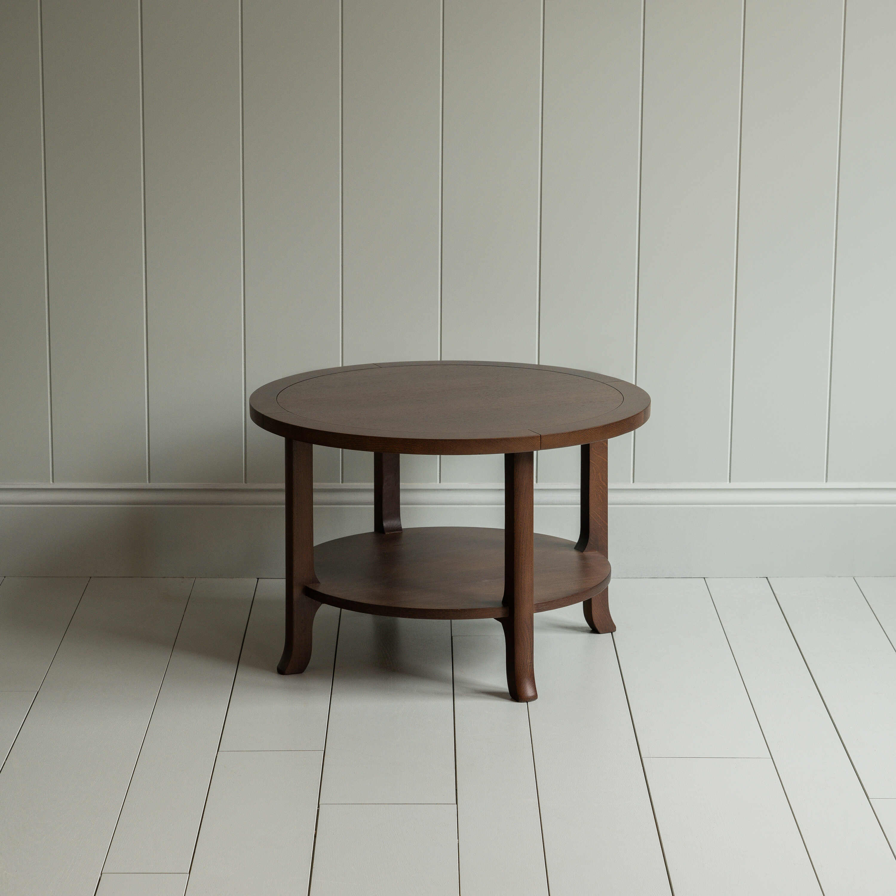 A circular wooden table with sturdy wooden base.