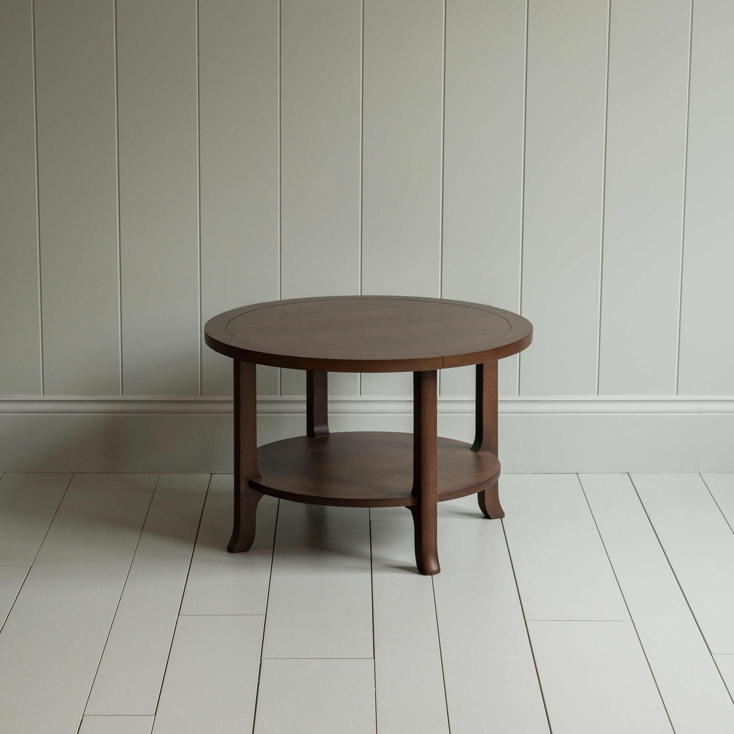 A circular wooden table with sturdy wooden base.