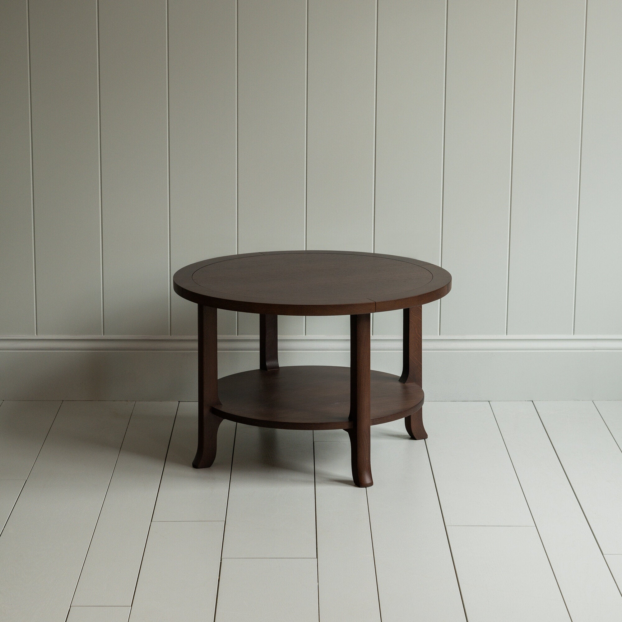 A circular wooden table with sturdy wooden base.