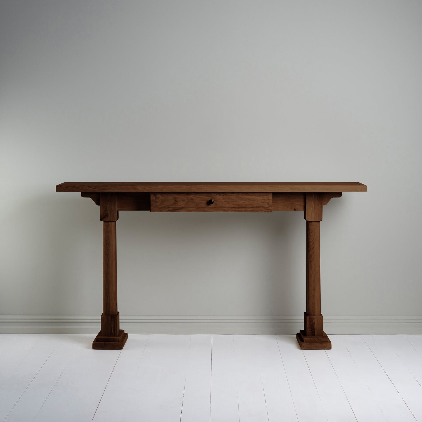 Console Table with a drawer in smoky stained oak, placed against the wall.
