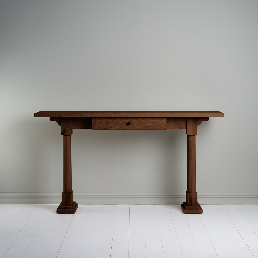 Console Table with a drawer in smoky stained oak, placed against the wall.