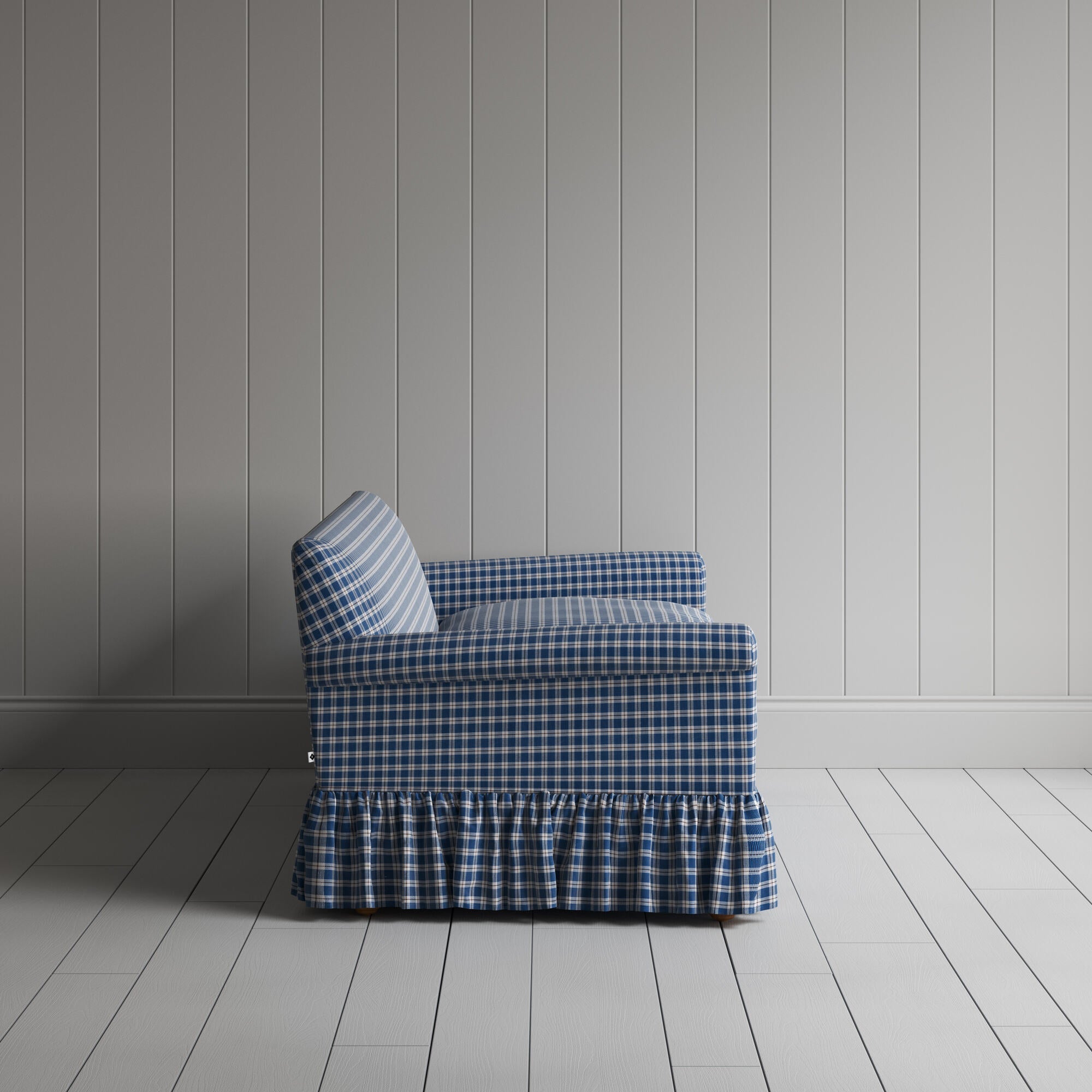 Elegant blue and white checkered sofa featuring a stylish ruffled skirt for a classic touch.