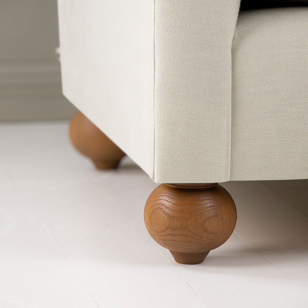 Close-up of a round wooden foot used by NiX in its sofas, designed by Nicola Harding & Co.