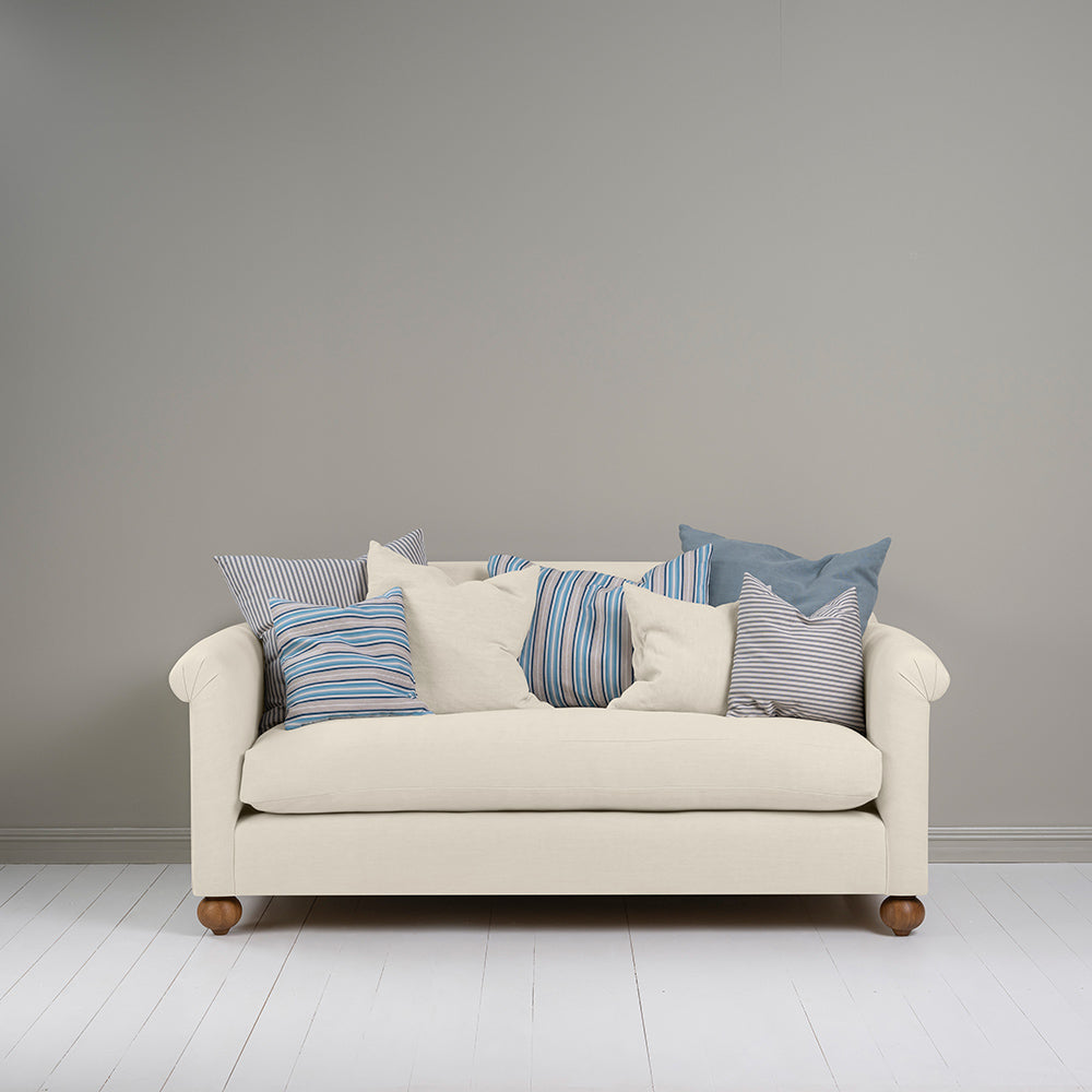 Front view of a 3-seater sofa in white (Dove) with multiple cushions, including three matching ones, designed by Nicola Harding.