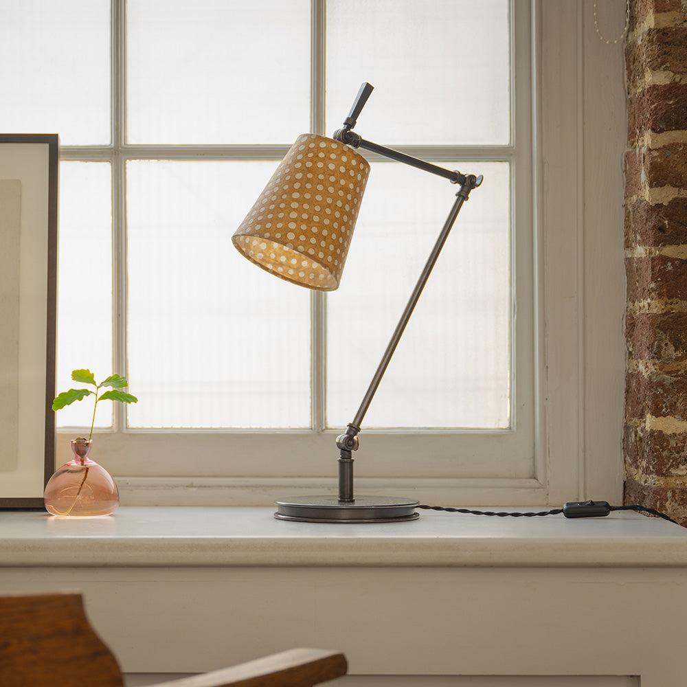 Focused Table Lamp Base in Waxed Brass, on a Fire Place Shelf With Focused Empire Batik Paper Lamp Shade in Spotty Dotty Tan - Nicola Harding