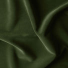 A close-up of a lush green velvet fabric with a smooth texture, perfect for luxurious upholstery or elegant clothing.