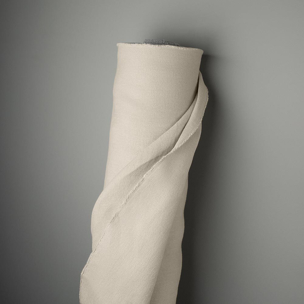 Laidback Linen, Dove fabric roll against the wall.