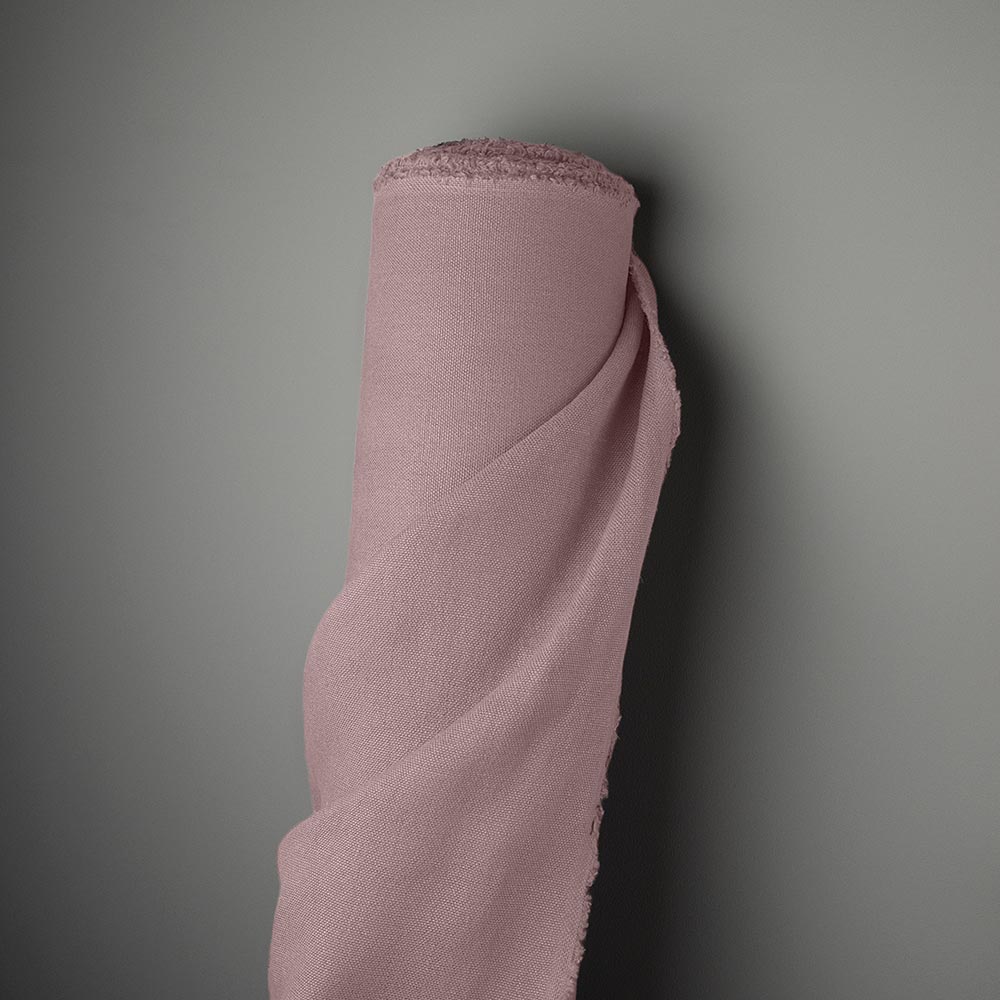 Laidback Linen heather fabric roll against the wall.