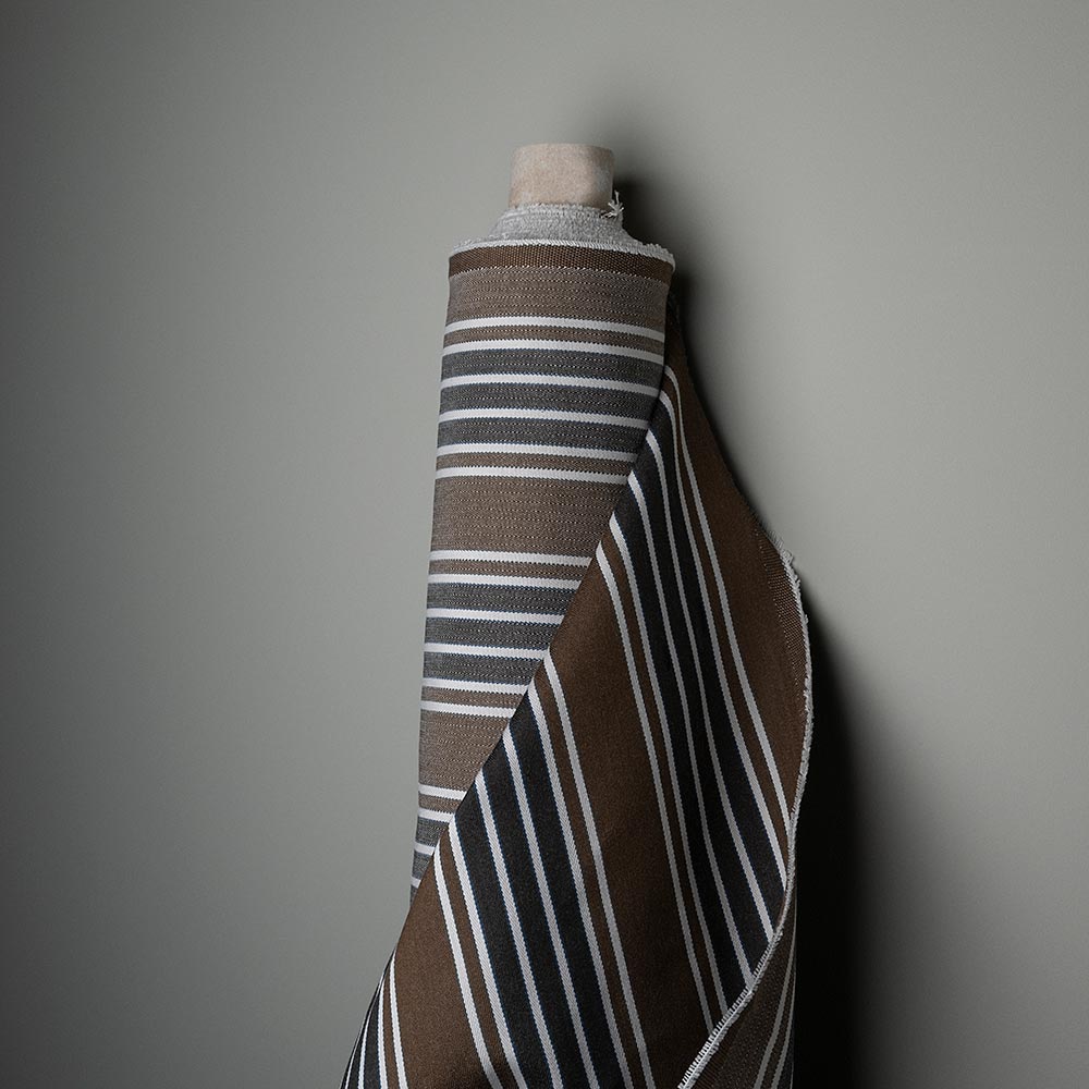 Mid-weight Organic Cotton, Regatta Charcoal, Fabric Roll Next to a Wall - Nicola Harding & Co.
