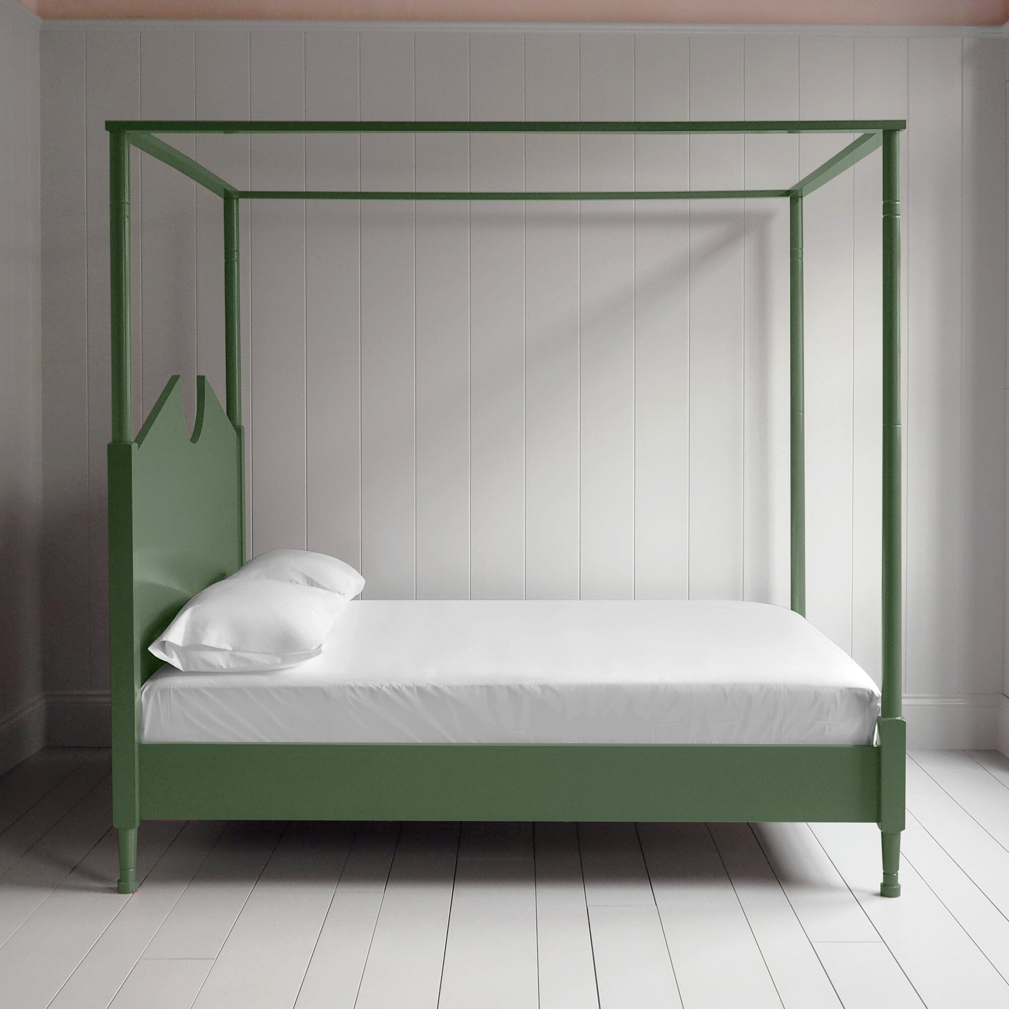 A green canopy bed with crisp white sheets, creating a serene and elegant atmosphere.
