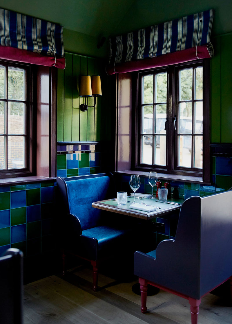 A table with two chairs, ready for a meal or a meeting. Designed By Nicola Harding & Co.