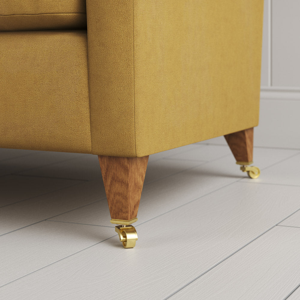 Detail of the feet and castors on the Ochre linen Idler by Nix.