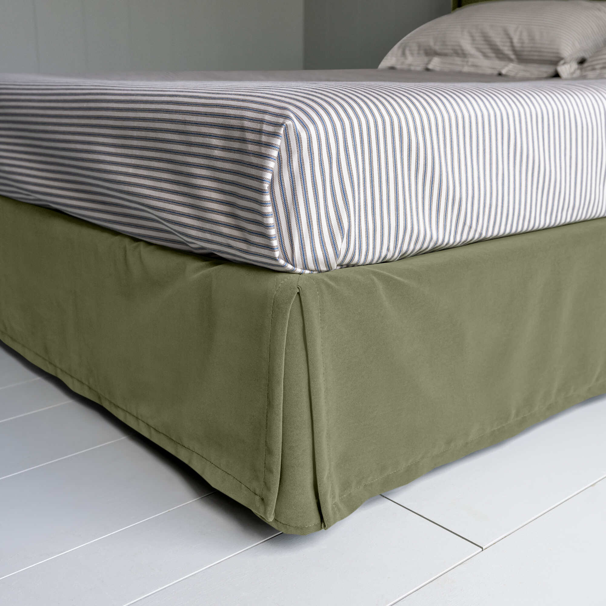 Cloud Nine Upholstered Bed in Intelligent Velvet Green Tea with Kick Pleat Valance, showcasing the edge design and a neatly tucked-in bedsheet.