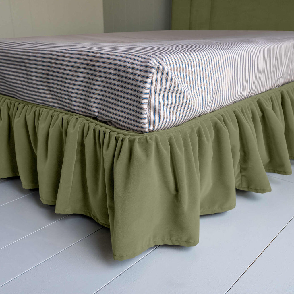 Cloud Nine Upholstered Bed in Intelligent Velvet Green Tea with Ruffled Valance, showcasing the edge design and a neatly tucked-in bedsheet.