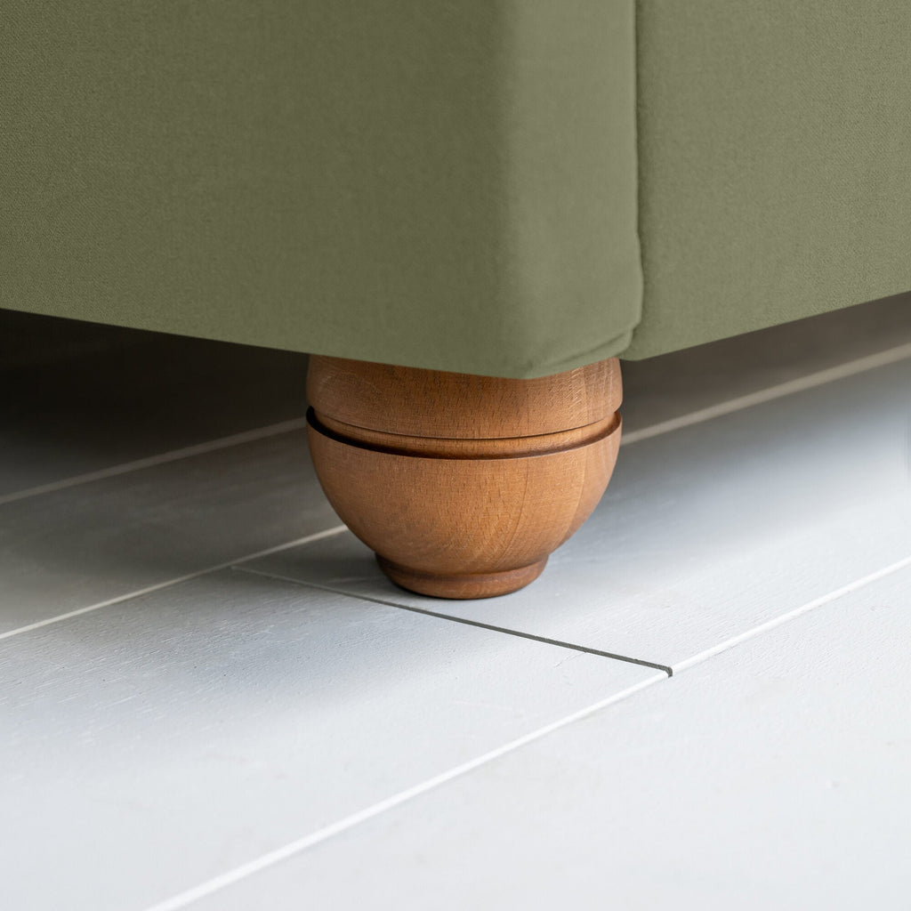 King-size upholstered bed in luxurious velvet green tea fabric with a rounded footboard design.