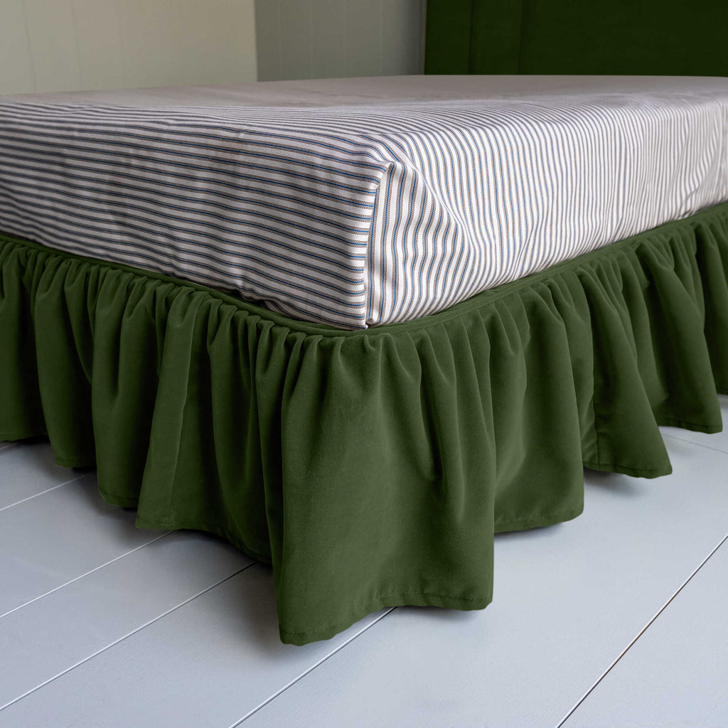 Seventh Heaven Upholstered Bed in Intelligent Velvet Juniper with Ruffled Valance, showcasing the edge design and a neatly tucked-in bedsheet.