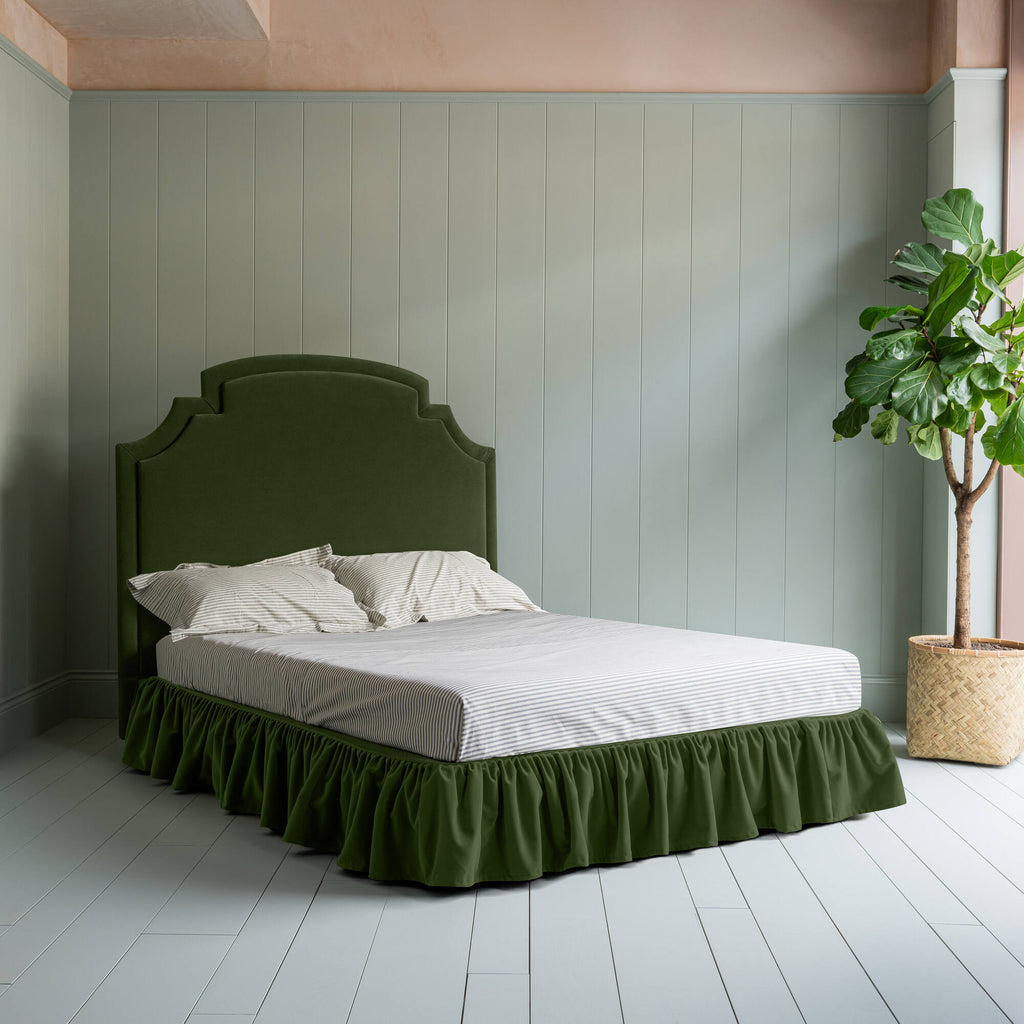 Seventh Heaven Upholstered Bed in Intelligent Velvet Juniper with Ruffled Valance complete bed picture with an indoor plant on the left.