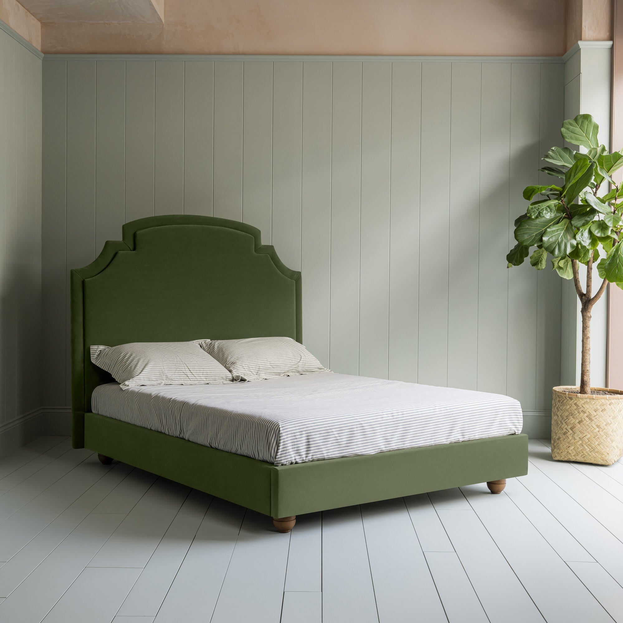 Seventh Heaven Upholstered Bed in Intelligent Velvet Juniper without Valance complete bed picture with an indoor plant on the left.