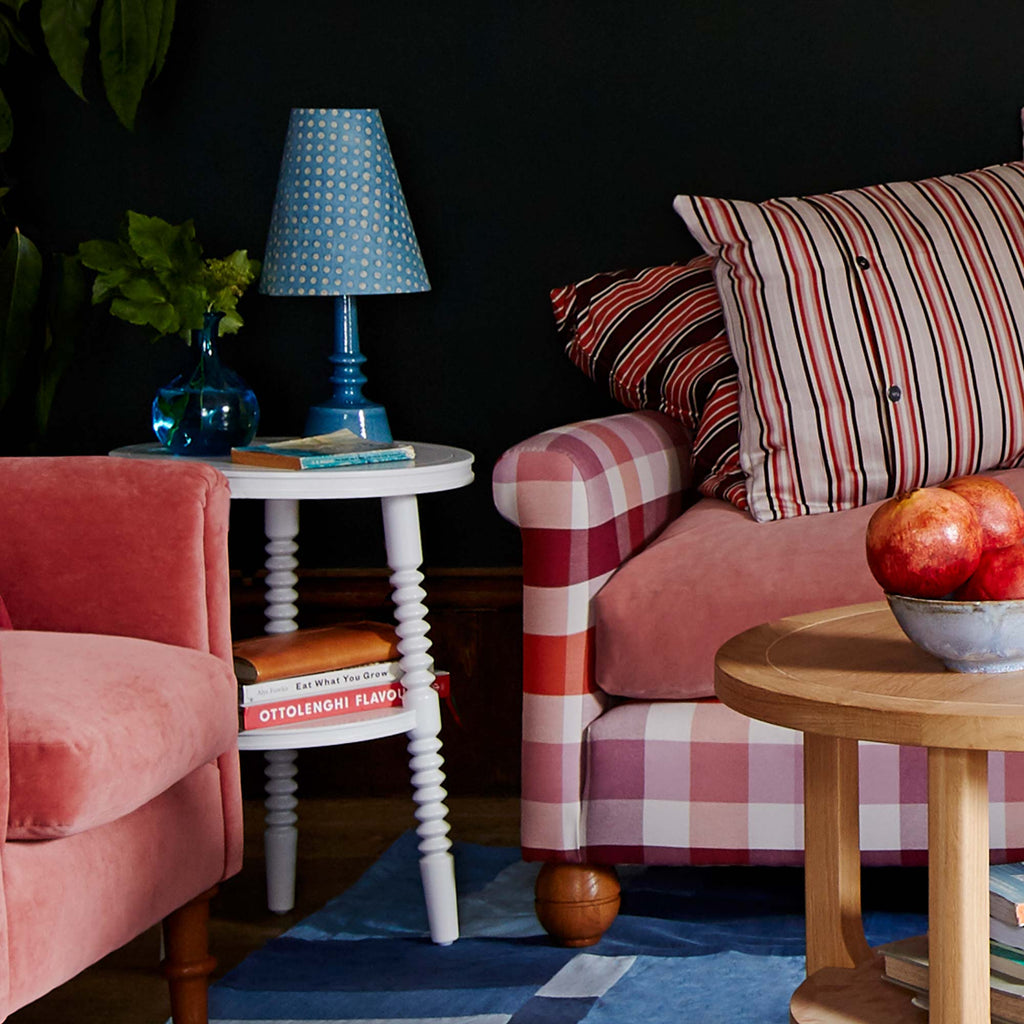 Ditsy Tall Tapered Lamp Shade in Dotty Sky Blue, With Ditsy Ceramic Table Lamp Base in Turquoise, On White Spindle Side Table, Next to an Armchair and a Sofa - Nicola Harding