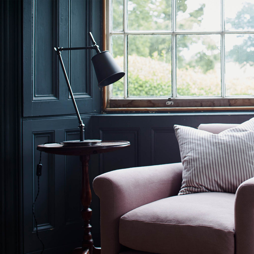 Focused Empire Lamp Shade in Waxed Brass with Rolled Edge, On a Side table Next to a NiX Armchair - Nicola Harding