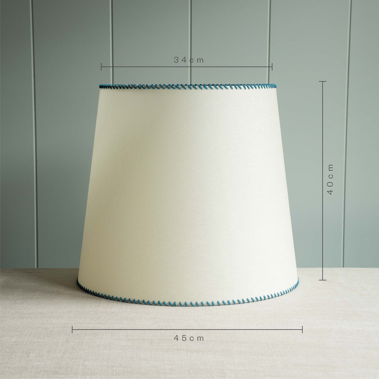 Measurements in 'cm' of Large Rise Empire Lamp Shade in Natural Parchment with Peacock Blue Stitching, Height is 40cm, Top-Width 34cm and Bottom Width is 45cm - By NiX