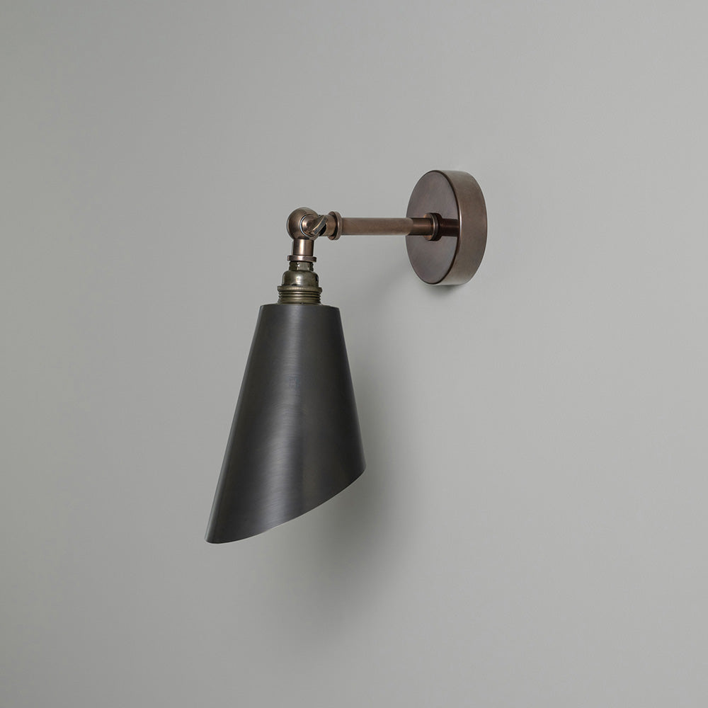 Black and bronze wall light with metal arm, perfect for modern decor.