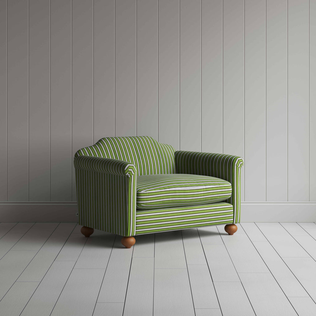 Green and white striped sofa on wooden floor.