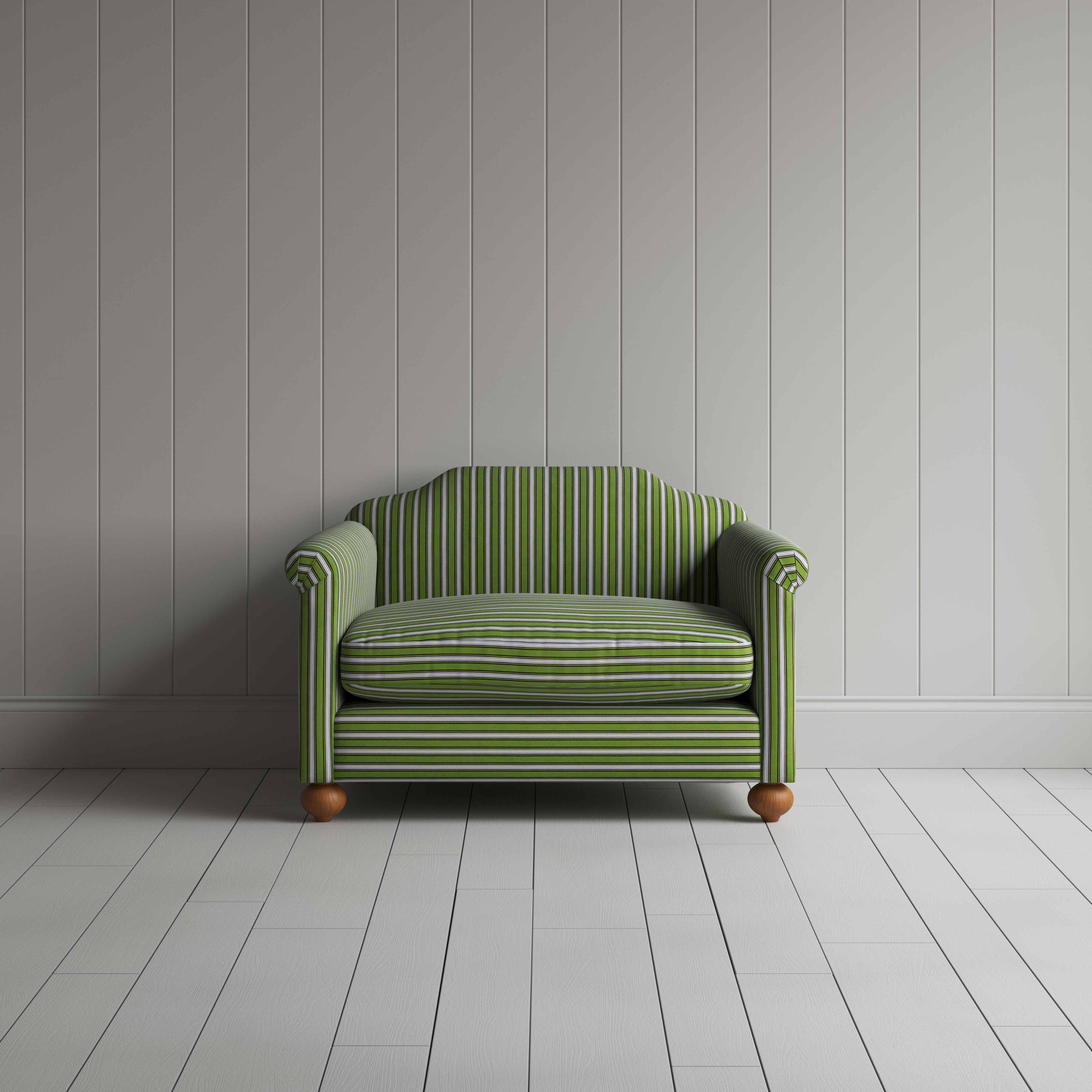 A modern green and white striped couch in a room with a minimalist design.
