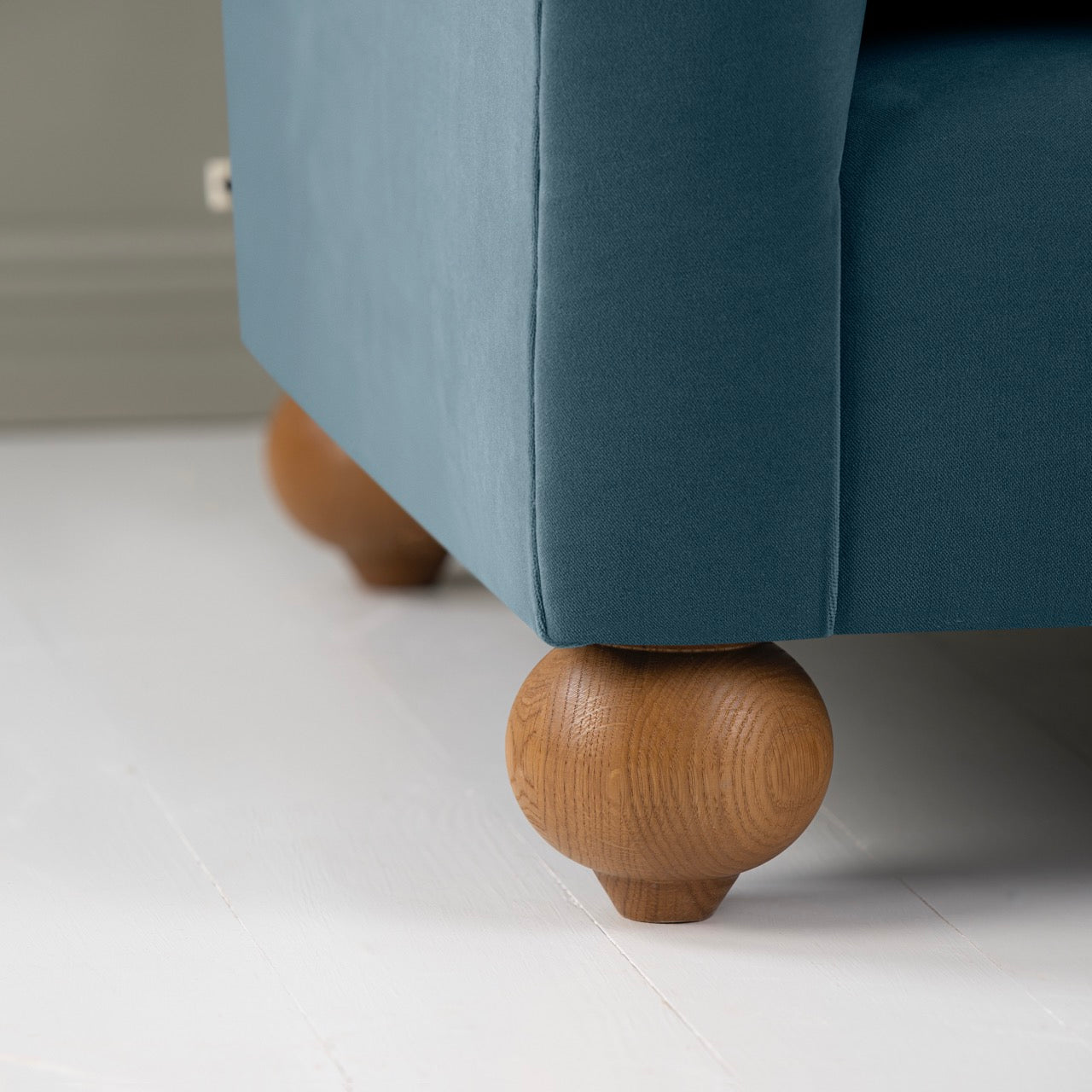 Dolittle Love Seat in Intelligent Velvet Aegean, With Round Wooden Foot Closeup - Nicola Harding