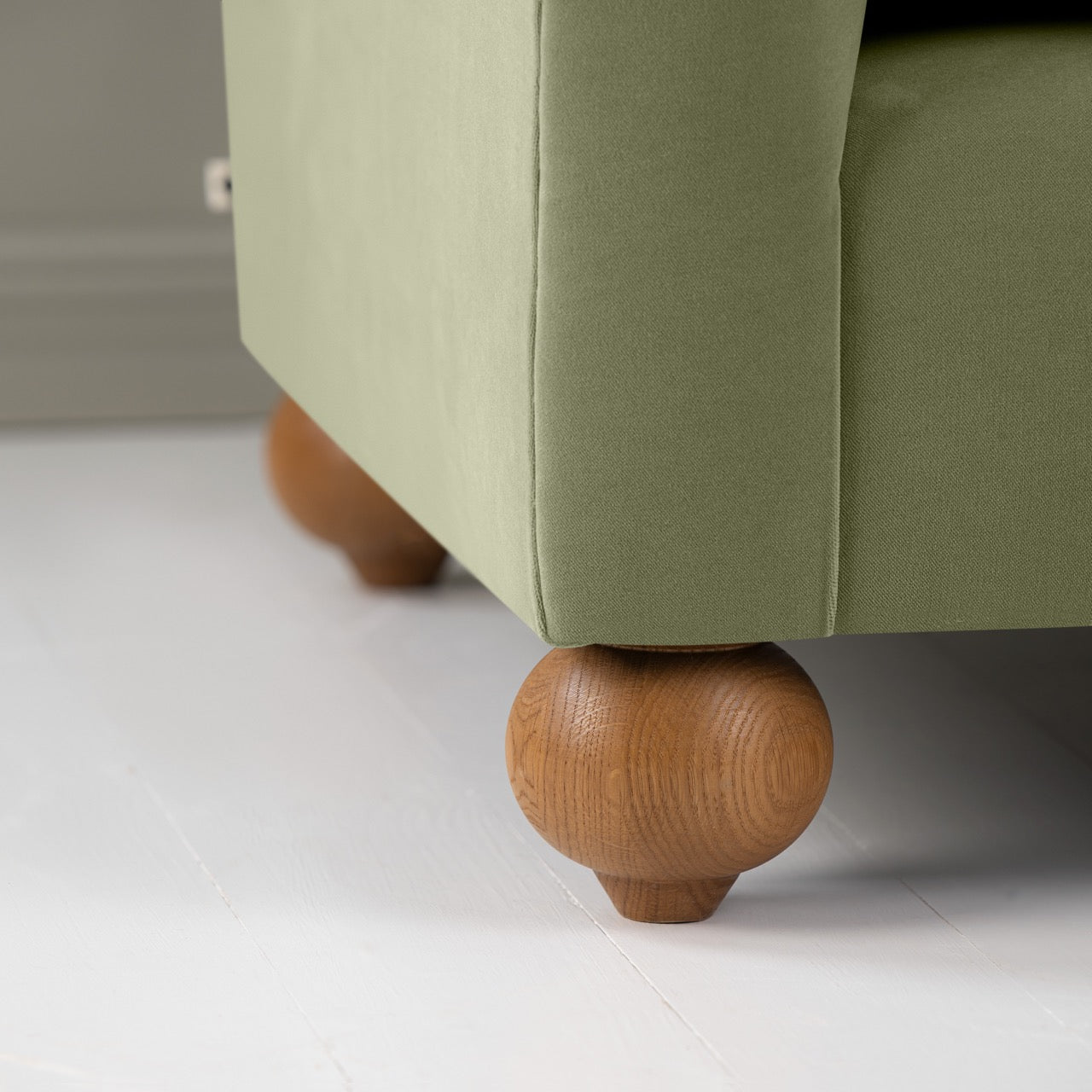 Dolittle Love Seat in Intelligent Velvet Green Tea, Round Wooden Foot Closeup - Nicola Harding