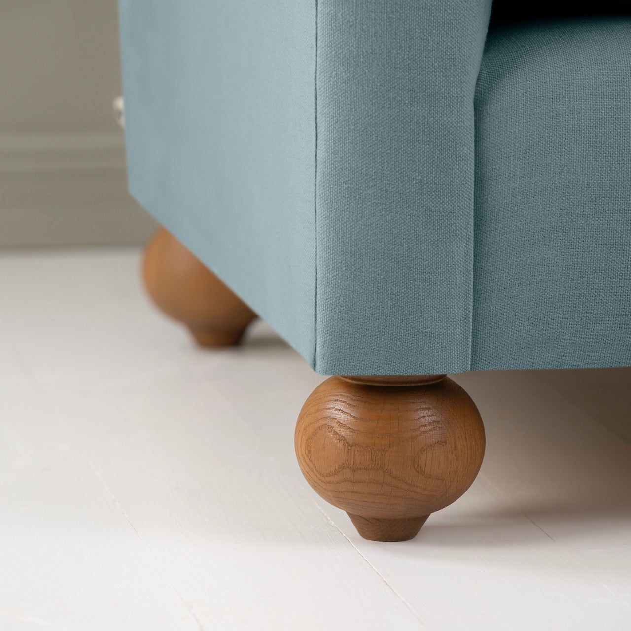 Dolittle Love Seat in Laidback Linen Cerulean, Round Wooden Feet Closeup - Nicola Harding
