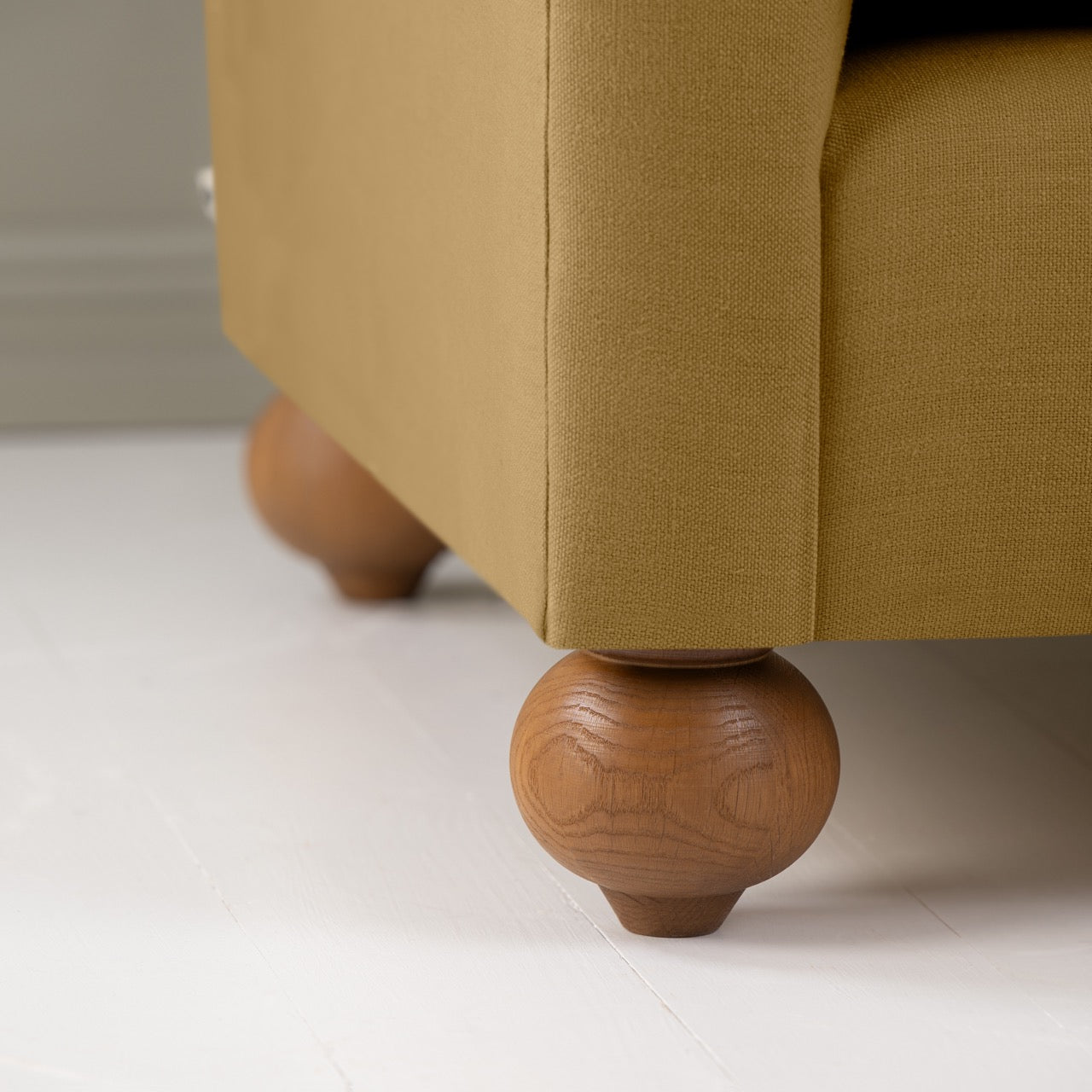 Dolittle Love Seat in Laidback Linen Ochre, Round Wooden Feet Closeup - Nicola Harding