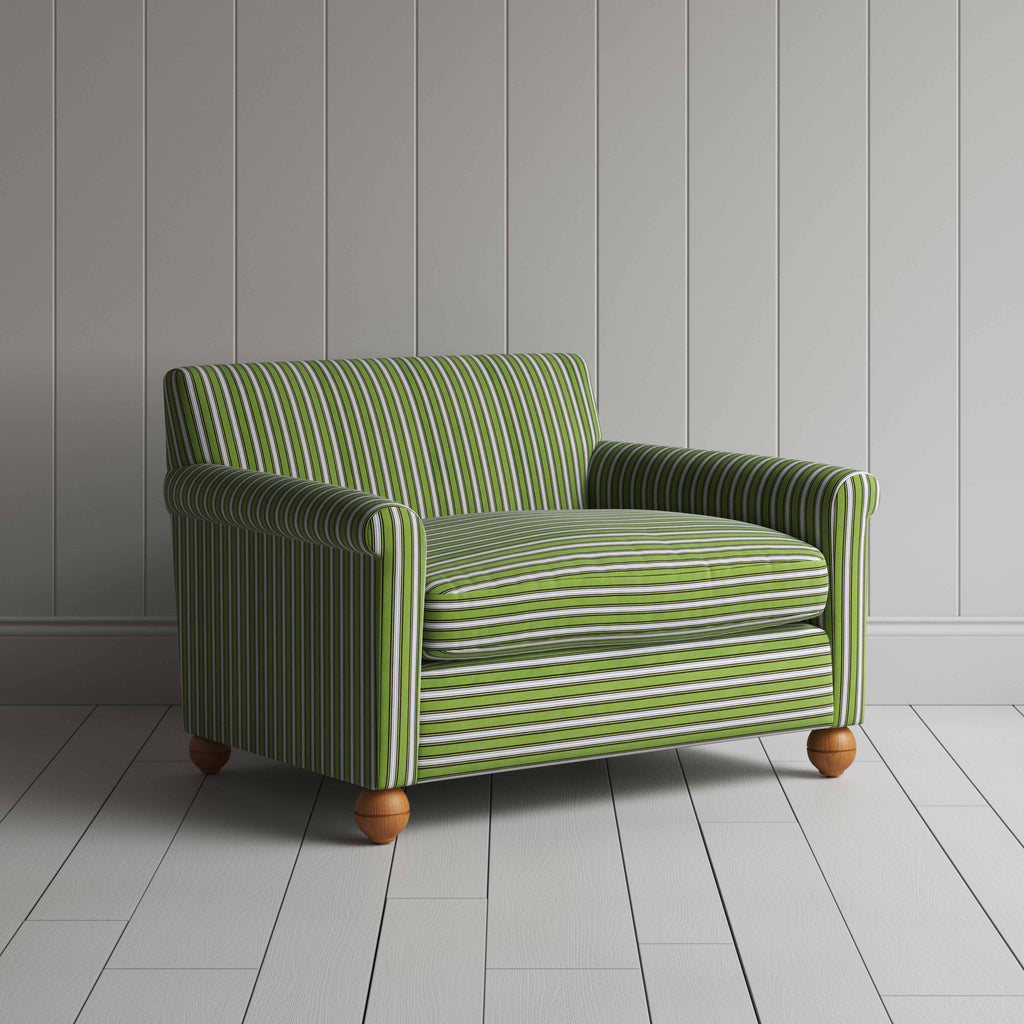 Striped green and white sofa by a wall.
