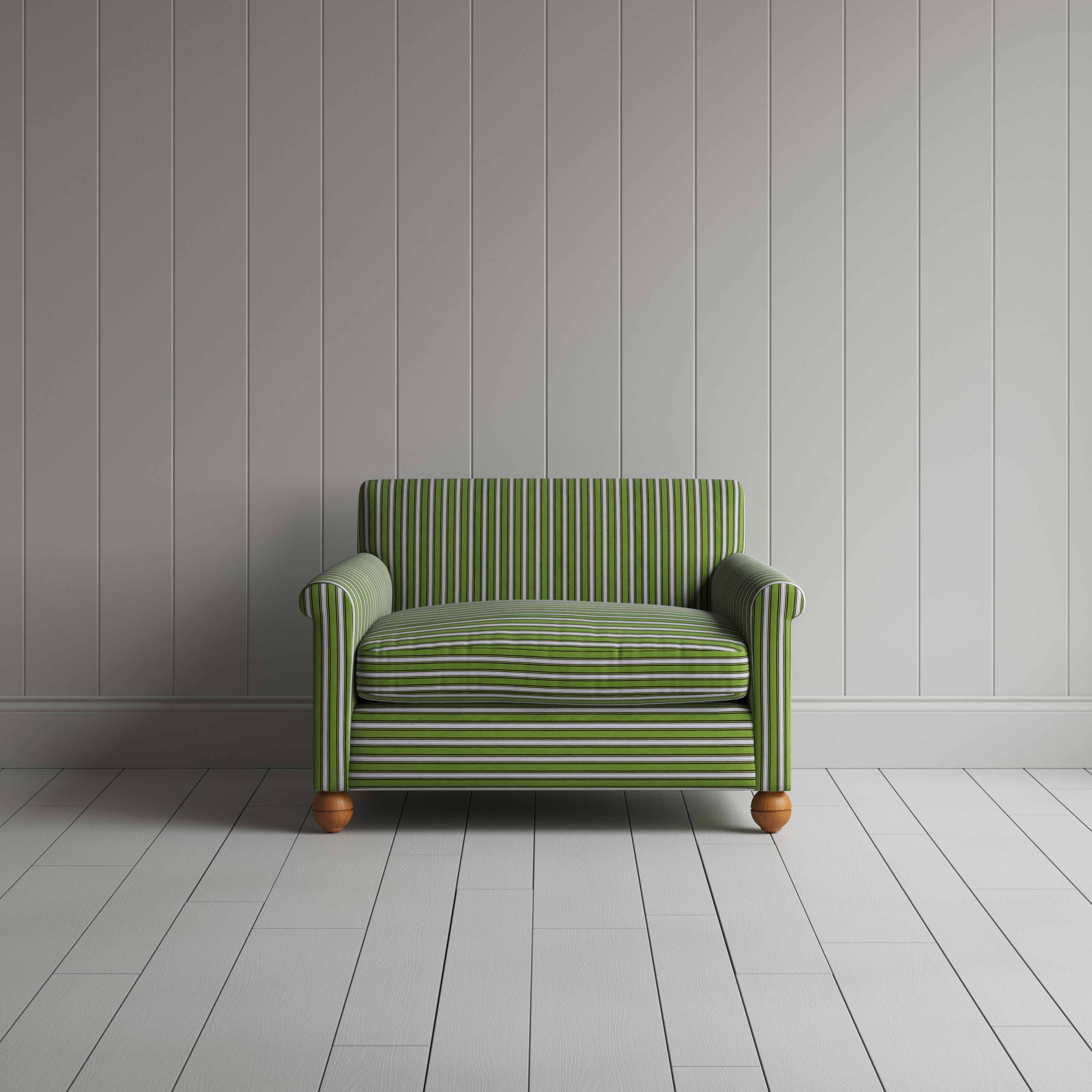 A green and white striped couch against a wall.