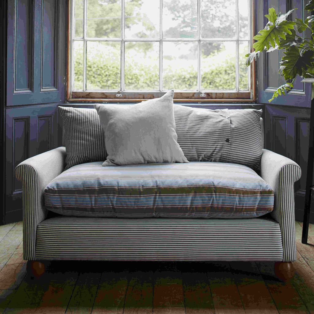 NiX Do-Little Loveseat With a Cushion, and a Window in the Background - NiX By Nicola Harding